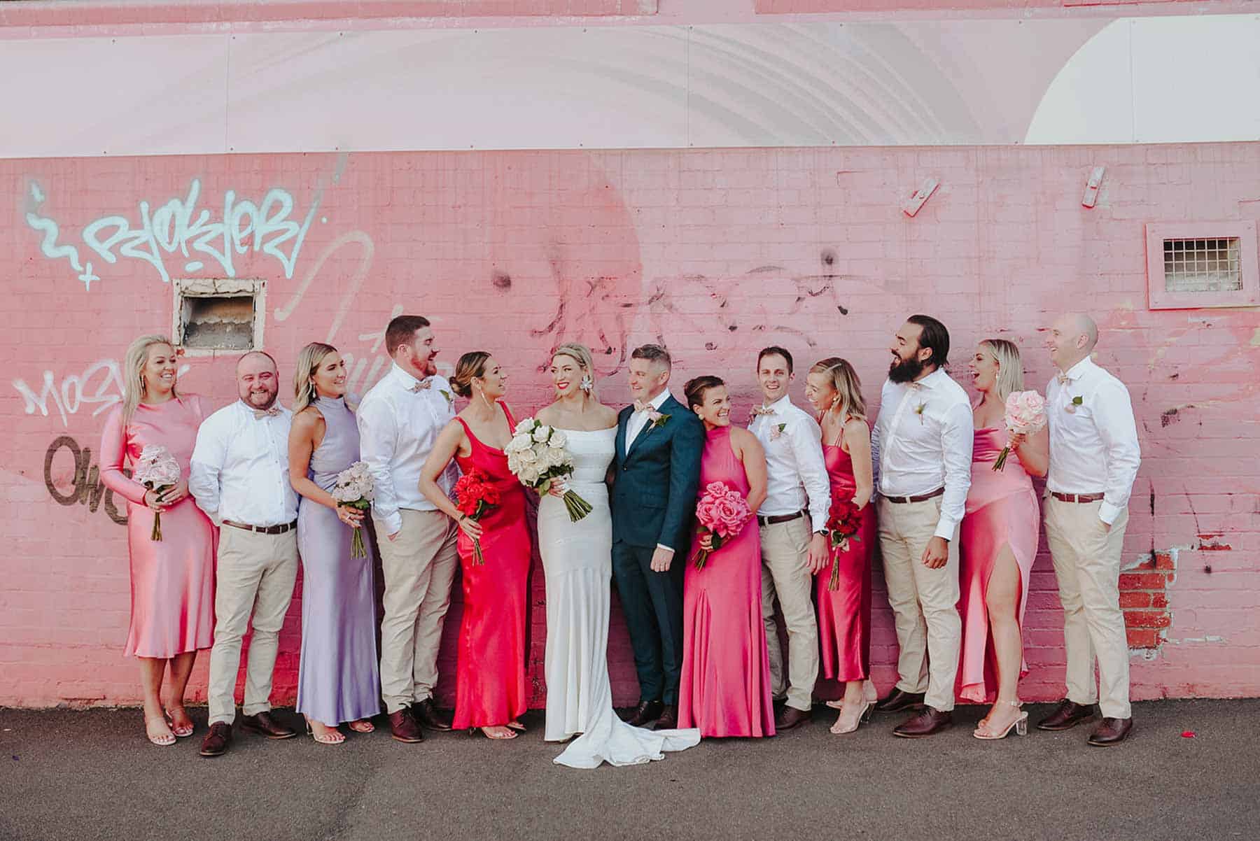 colourful bridesmaids in mixed red and pink dresses