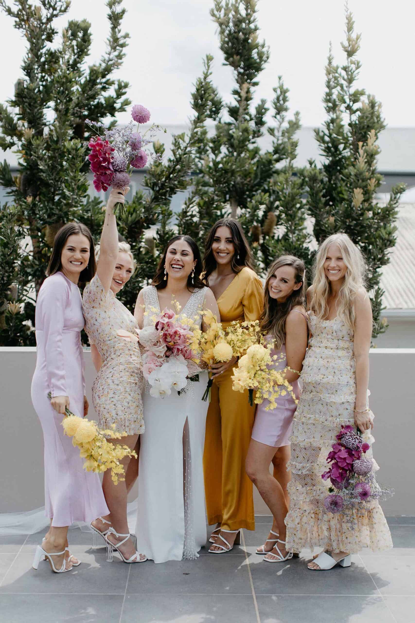 mismatched bridesmaid dresses in pink white and yellow