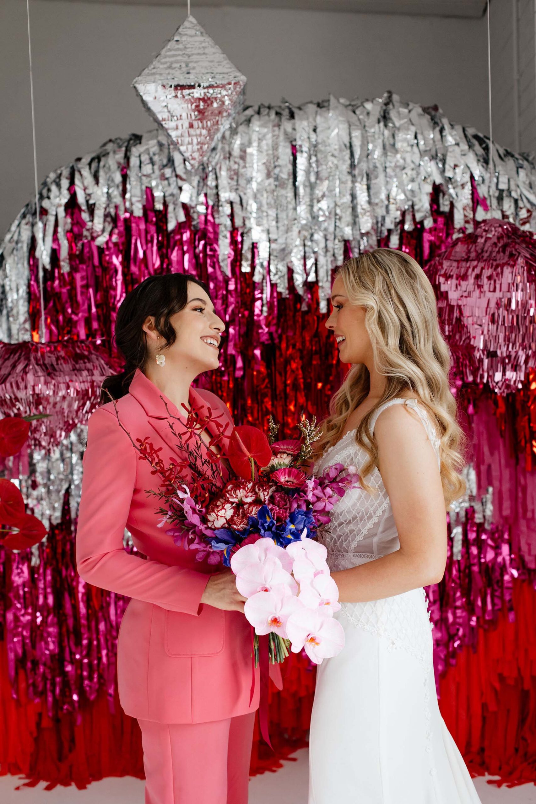 Pink wedding ceremony with streamer backdrop